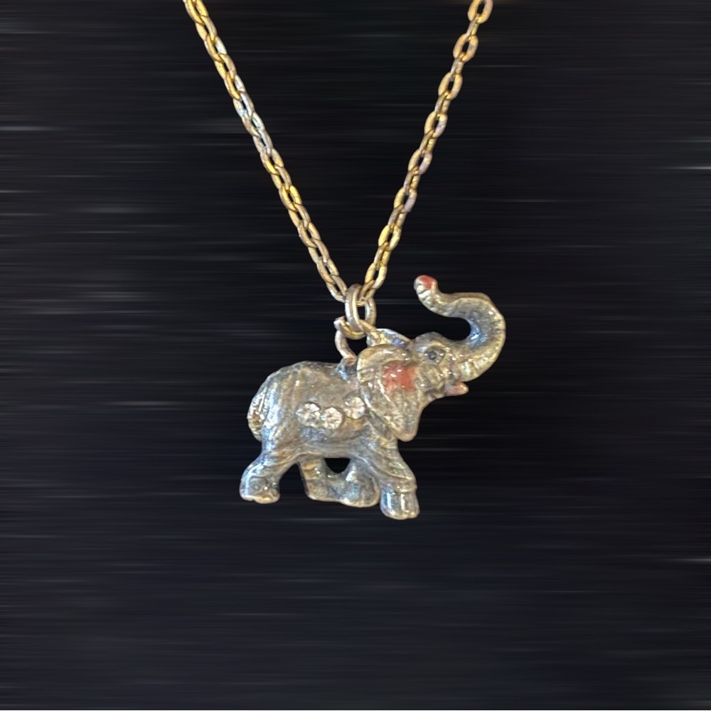 pewter elephant necklace pendant with gemstone eyes in motion